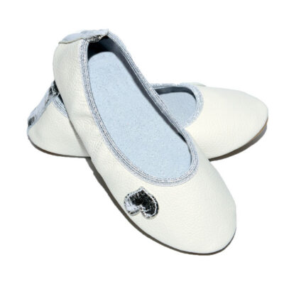 White leather ballet flats with light blue lining and a silver heart embellishment on the toe